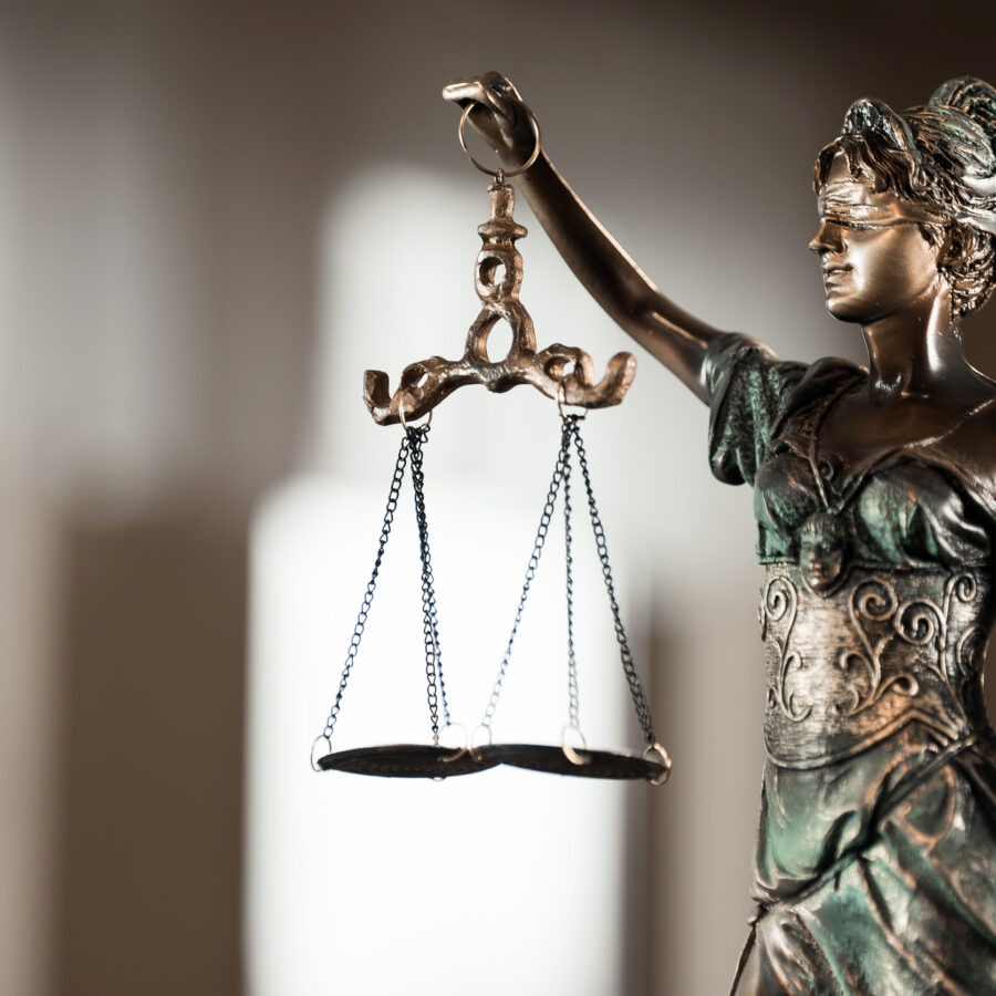 Law and Justice concept. Mallet of the judge, books, scales of justice. Courtroom theme.