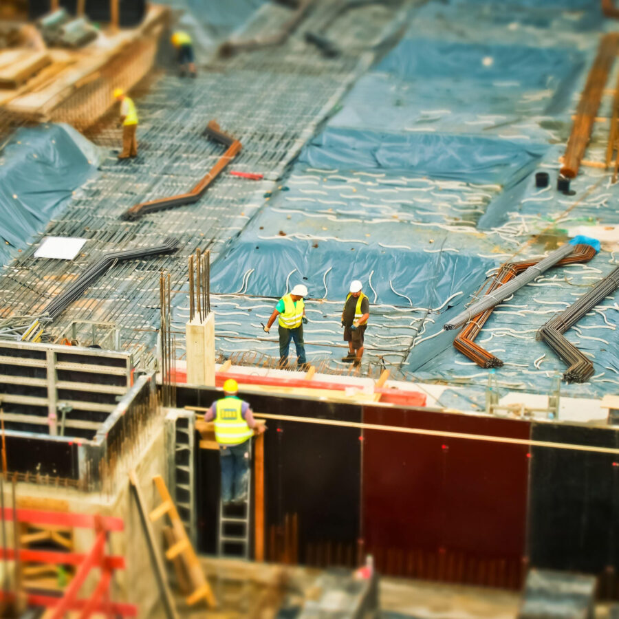 Man in Yellow Safety Vest Climbing on Ladder